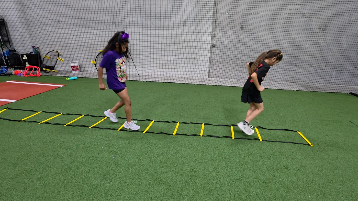 Young athletes running agility ladder drills at PlayForge Athletics in League City, TX