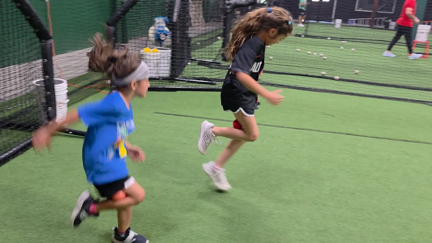 Young athletes doing knee-drive speed drills at PlayForge Athletics